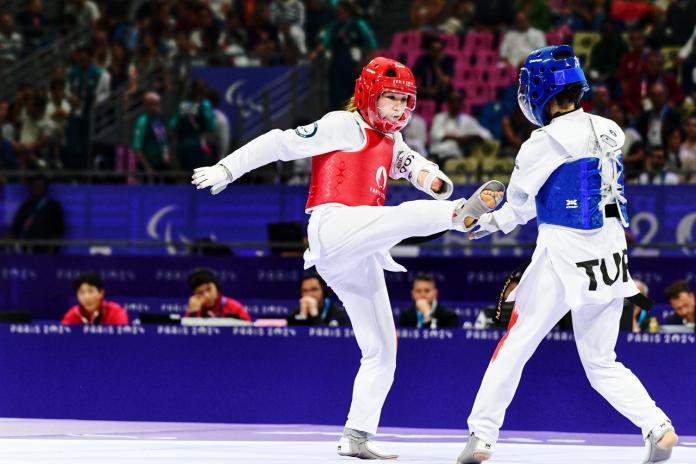 Two female Para taekwondo athletes competing